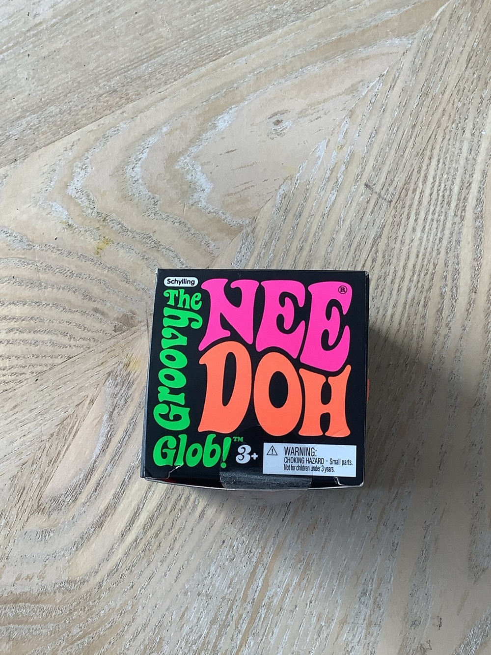 Groovy NeeDoh Glob Kids Stress Toy — Black Packaging with Pink & Orange Text